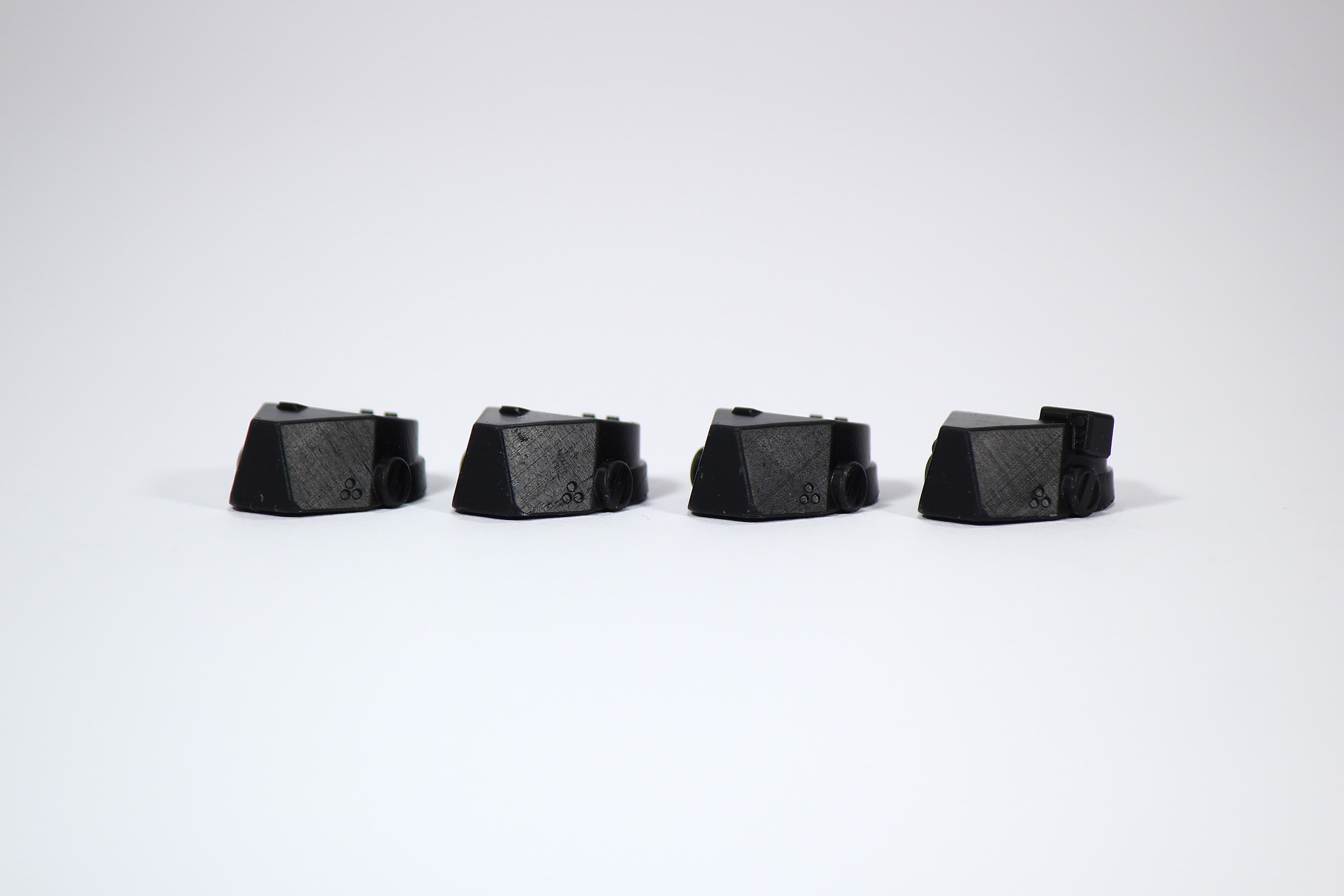Resin printed Monolith Optics components showing visible layer lines and surface variation